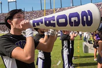 TCU yell leader holding megaphone